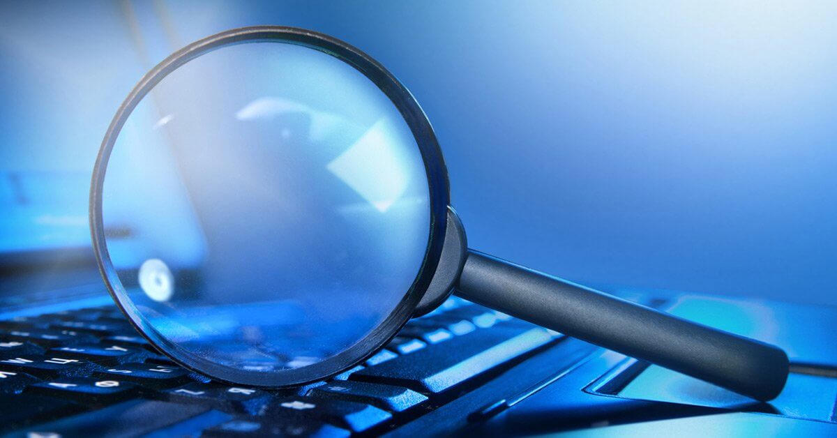 magnifying glass on close up of computer keyboard